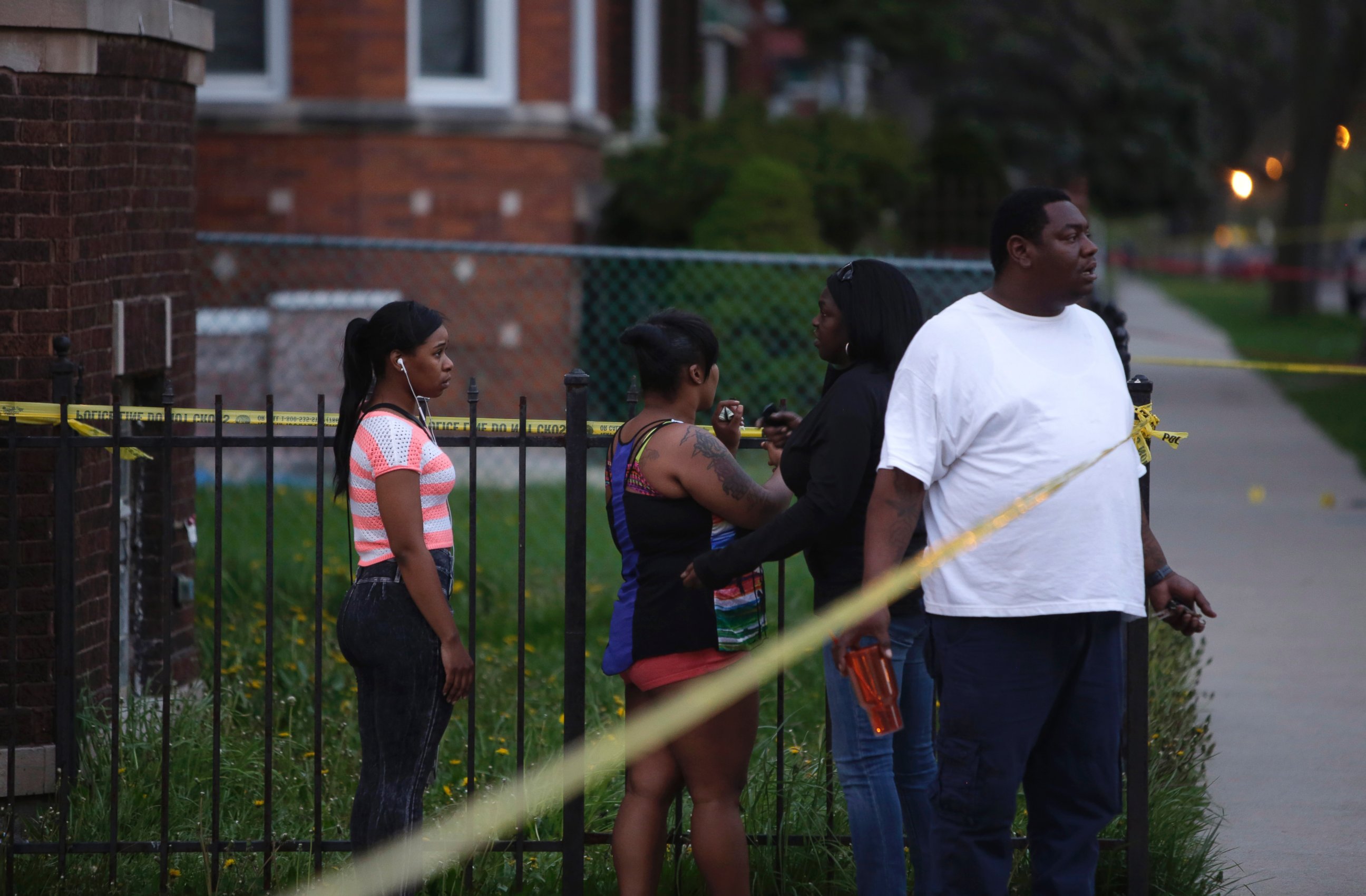 PHOTO: People watch as Chicago Police officers and evidence technicians investigate the scene where a 16-year-old boy was shot in the head and killed and another 18-year-old man was shot and wounded on April 25, 2016, in Chicago.