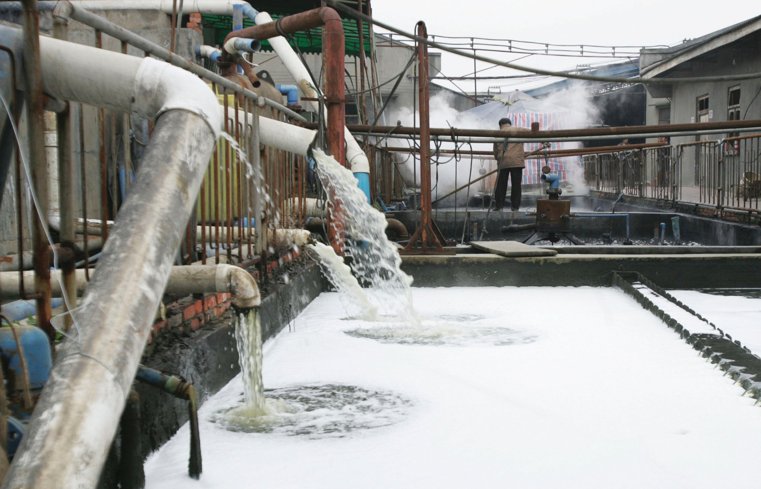 PHOTO: Pipes emit waste water into a wastewater treatment pond at a garments factory, Dec. 5, 2005 in Chengdu of Sichuan Province, China. 
