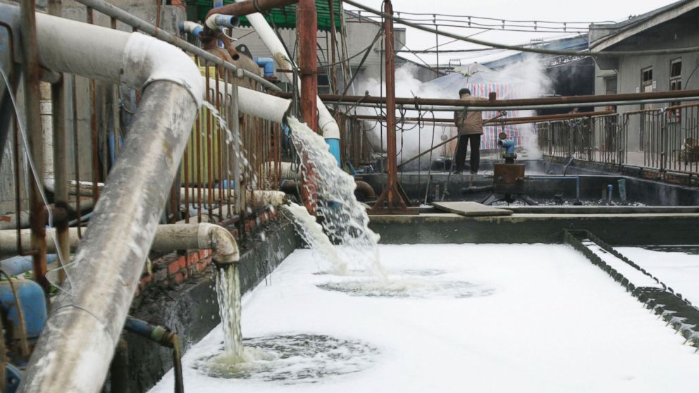 PHOTO: Pipes emit waste water into a wastewater treatment pond at a garments factory, Dec. 5, 2005 in Chengdu of Sichuan Province, China. 