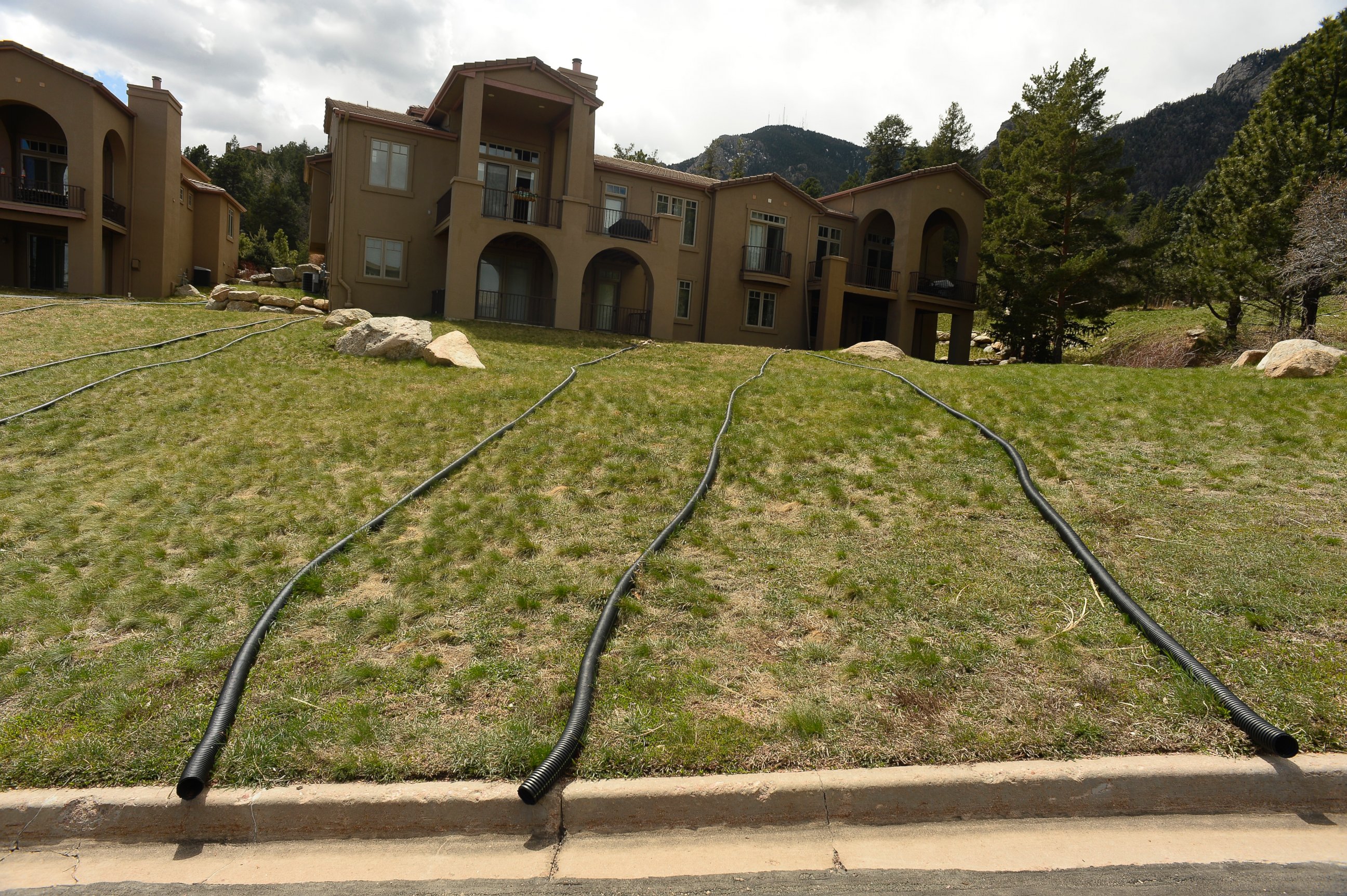 PHOTO: Homeowners have put in water diversion pipes off their roofs to the street to keep water away from their homes near the Broadmoor Mountain Golf Course, where landslides are causing the earth to move, April 11, 2016 in Colorado Springs, Colorado. 