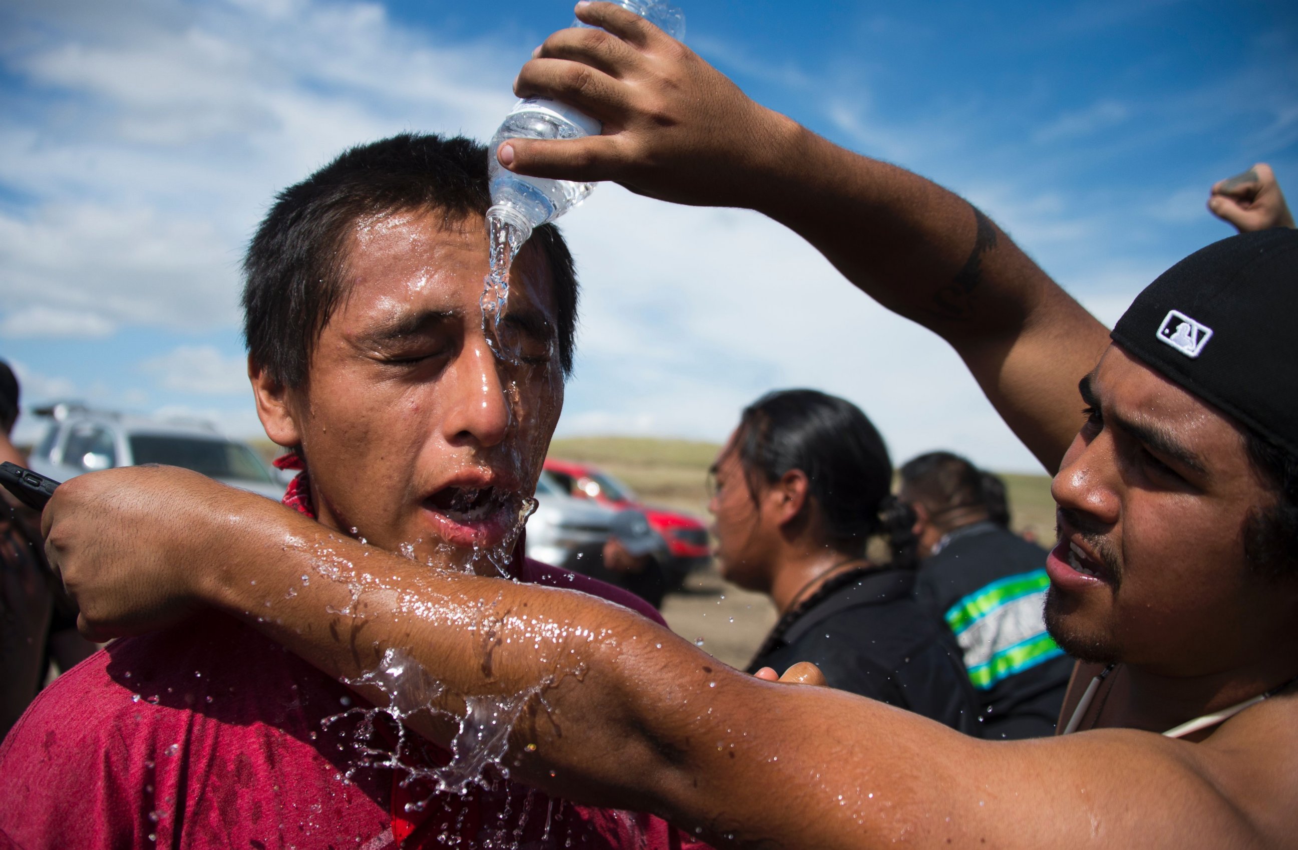 PHOTO: A man pours water over the eyes of a protestor after he was pepper-sprayed by security guards at a work site for the Dakota Access Pipeline (DAPL) oil pipeline, near Cannonball, North Dakota, Sept. 3, 2016.