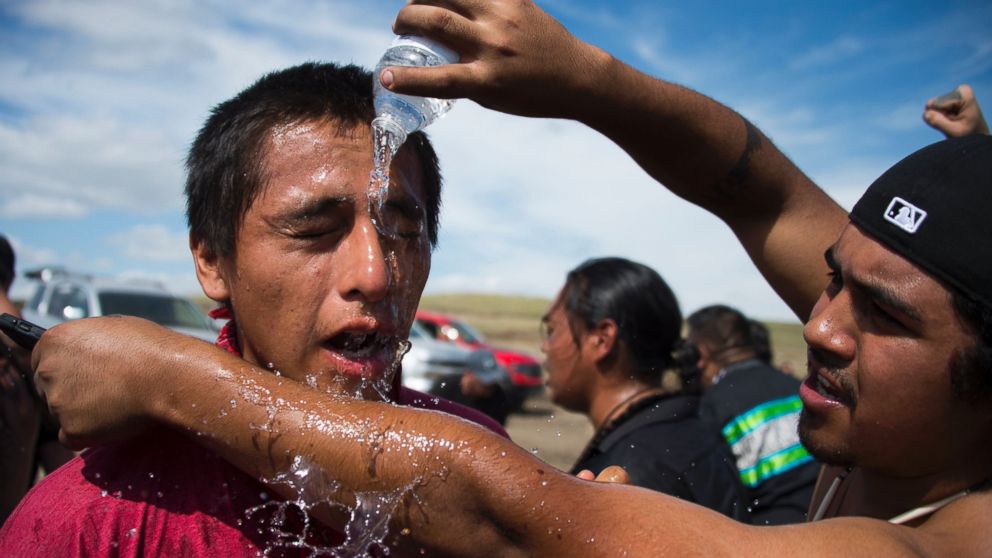 PHOTO: A man pours water over the eyes of a protestor after he was pepper-sprayed by security guards at a work site for the Dakota Access Pipeline (DAPL) oil pipeline, near Cannonball, North Dakota, Sept. 3, 2016.