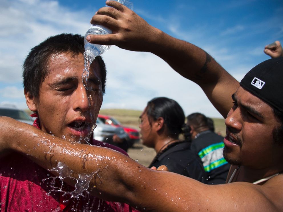 PHOTO: A man pours water over the eyes of a protestor after he was pepper-sprayed by security guards at a work site for the Dakota Access Pipeline (DAPL) oil pipeline, near Cannonball, North Dakota, Sept. 3, 2016.