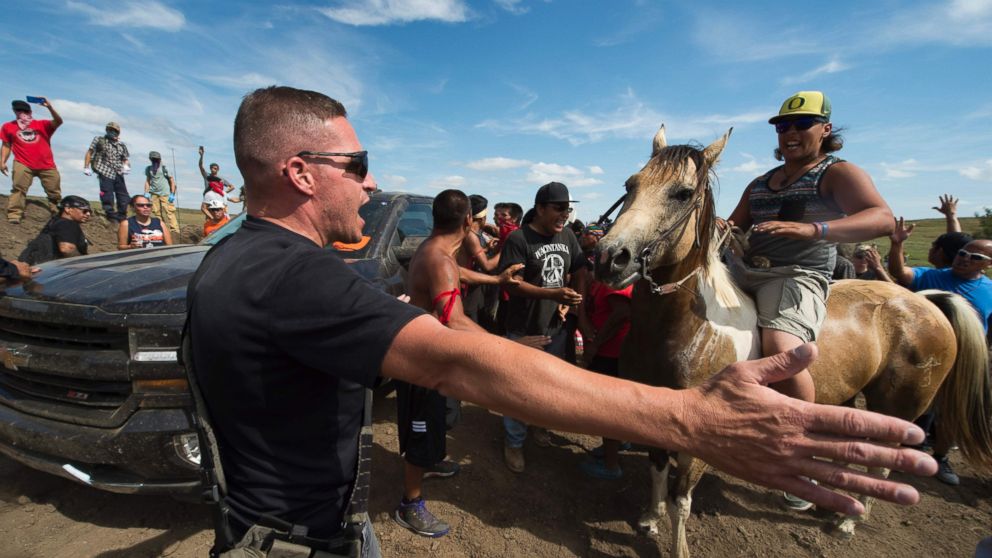 PHOTO: Native American protestors and their supporters are confronted by security during a demonstration against work being done for the Dakota Access Pipeline (DAPL) oil pipeline, near Cannonball, North Dakota, Sept. 3, 2016.