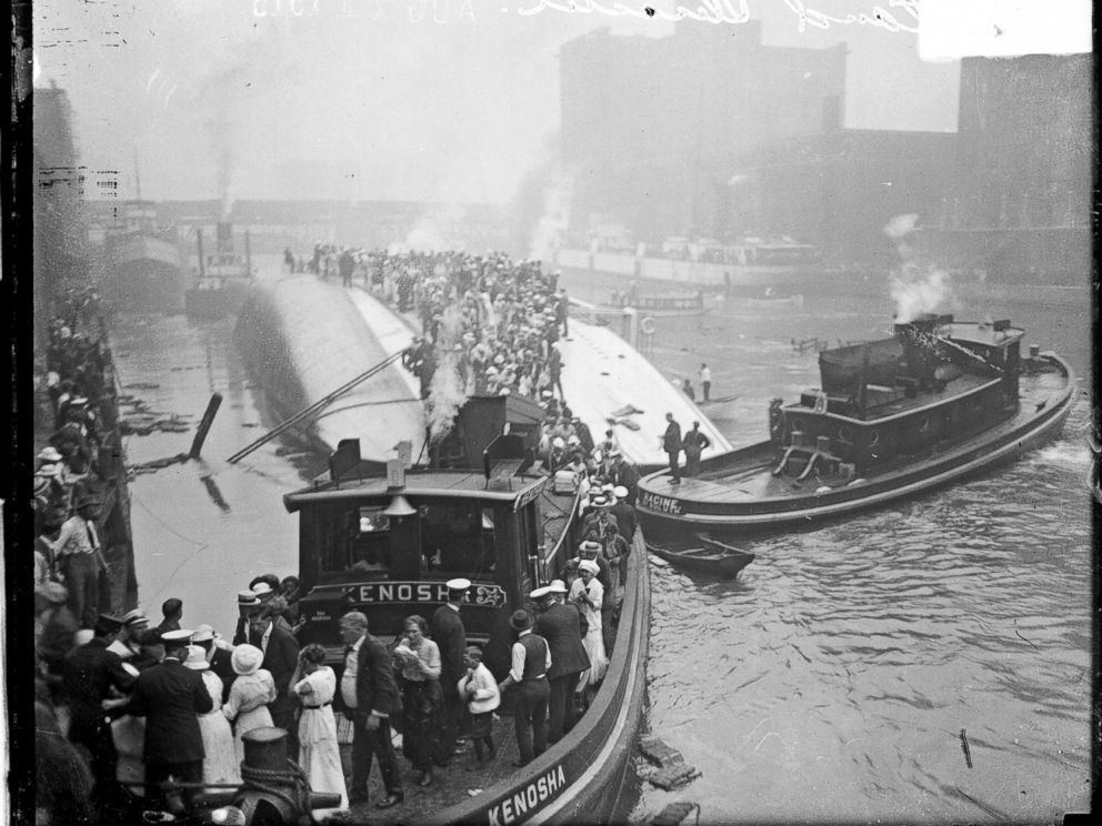 PHOTO: The Kenosha, a tugboat, rescuing survivors from the hull of the overturned Eastland steamer, Chicago, July 24, 1915.