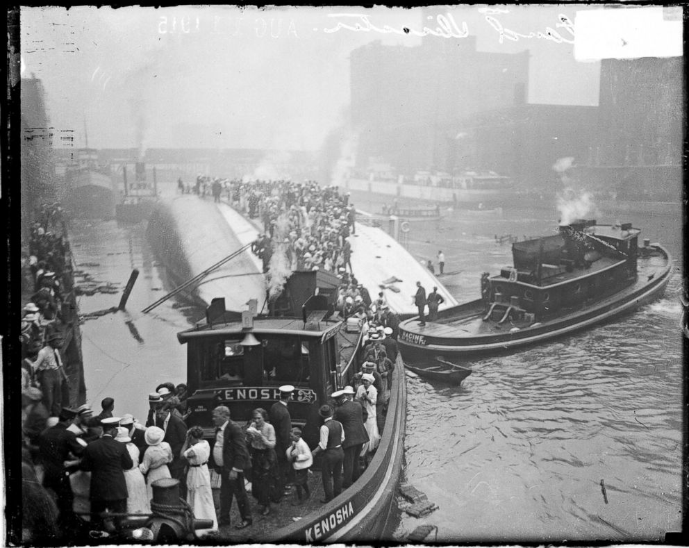 PHOTO: The Kenosha, a tugboat, rescuing survivors from the hull of the overturned Eastland steamer, Chicago, July 24, 1915.