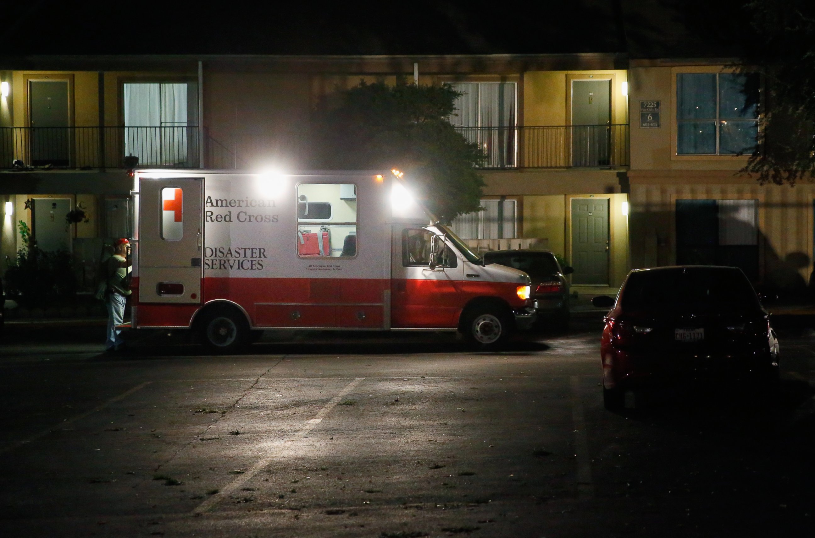 PHOTO: Volunteers from the Red Cross deliver blankets and other supplies to a unit at the Ivy Apartments, where the confirmed Ebola virus patient was staying, on Oct. 2, 2014 in Dallas, Texas. 