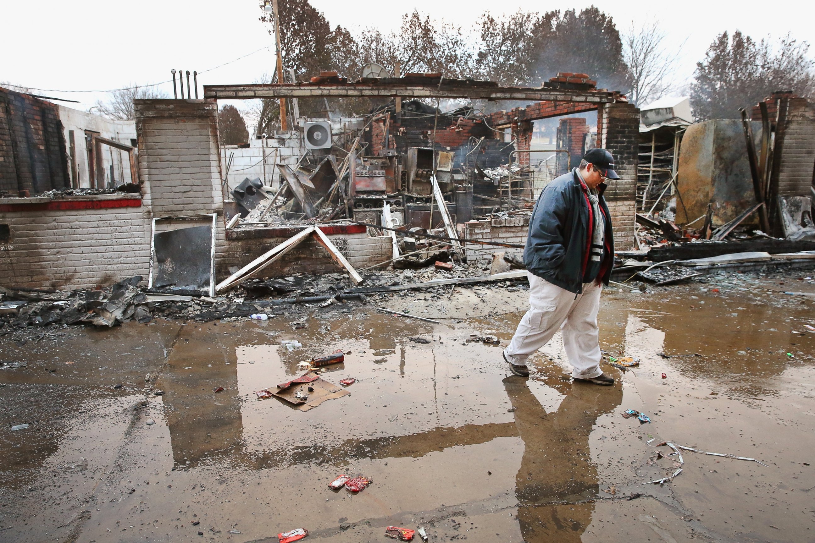 PHOTO: Property manager Terri Willits looks over a gas station she manages that was set on fire when rioting erupted following the grand jury announcement in the Michael Brown case, Nov. 25, 2014 in Dellword, Mo.