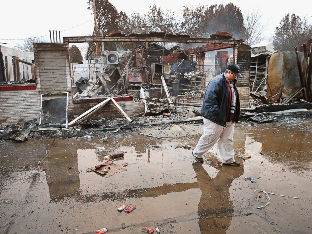 PHOTO: Property manager Terri Willits looks over a gas station she manages that was set on fire when rioting erupted following the grand jury announcement in the Michael Brown case, Nov. 25, 2014 in Dellword, Mo.