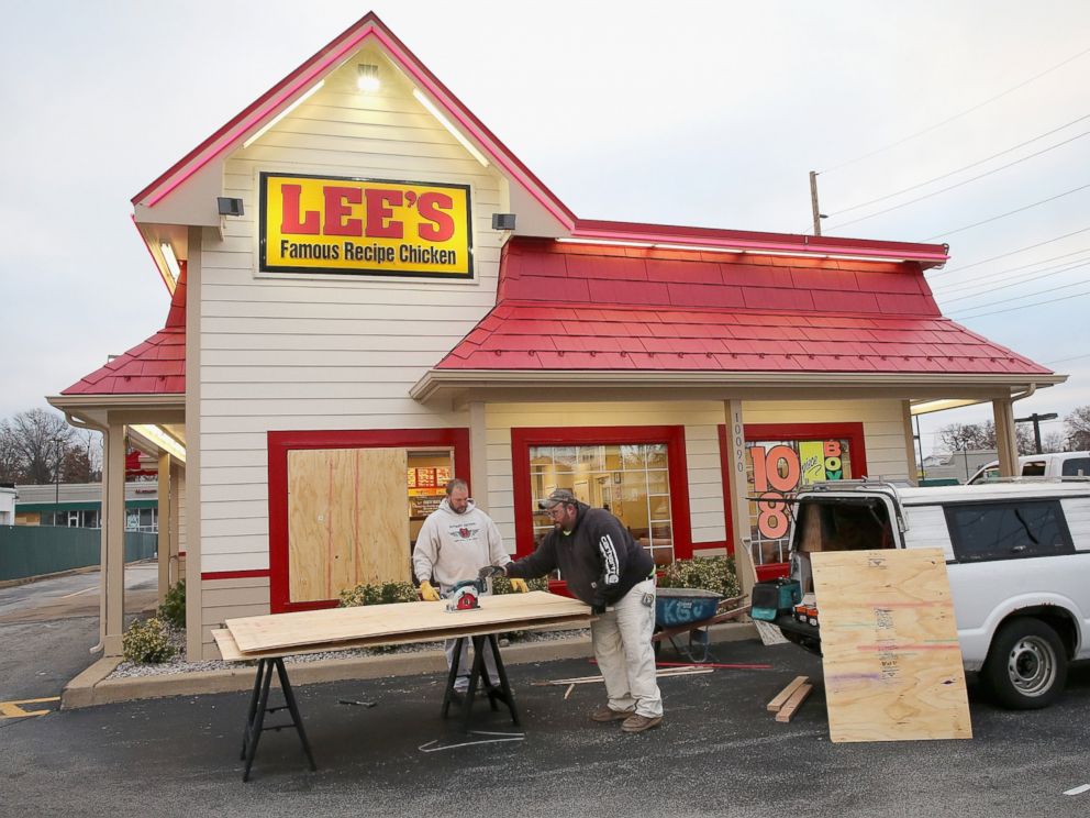 PHOTO: Workers board up a window of a restaurant after it was smashed when rioting erupted following the grand jury announcement in the Michael Brown case, Nov. 25, 2014 in Ferguson, Mo.