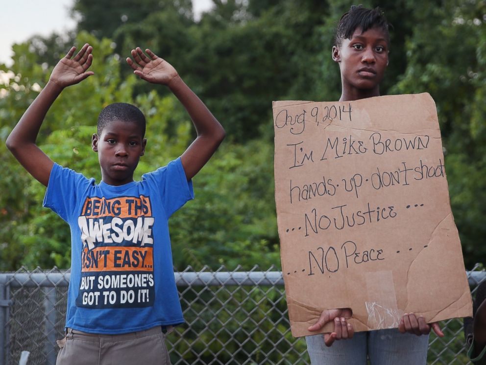 PHOTO: Leo Walker, left, and his sister Letrece, right, protest the killing of Michael Brown on Aug. 17, 2014 in Ferguson, Mo.