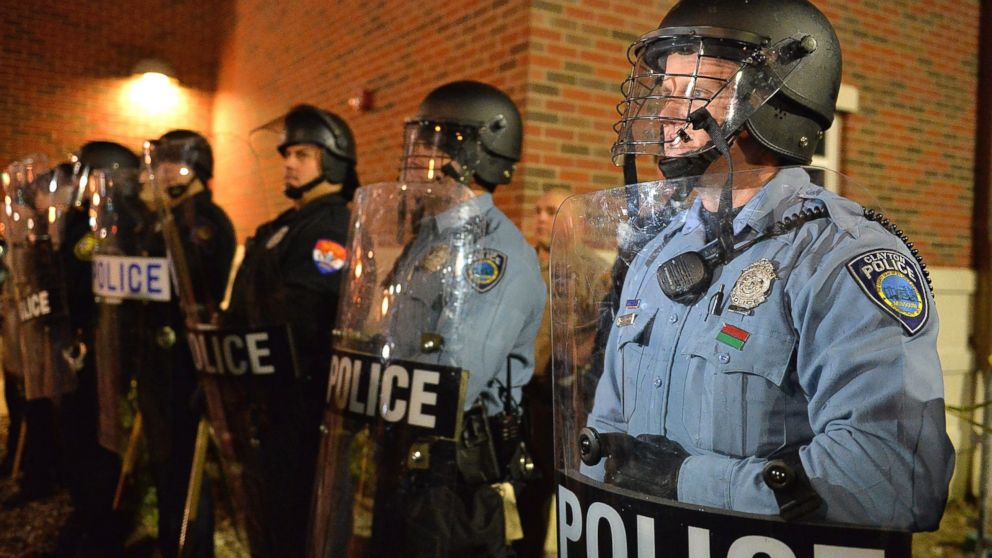 PHOTO: Police officers stand in riot gear during a protest, Nov. 19, 2014 outside the Ferguson Police Department in Ferguson, Mo.