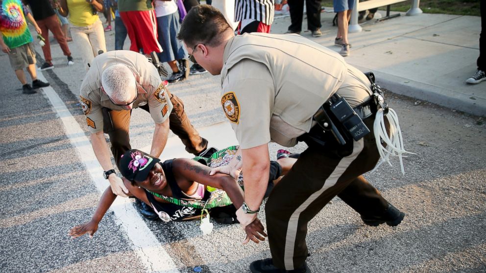 A demonstrator is arrested while protesting the killing of teenager Michael Brown, Aug. 19, 2014, in Ferguson, Mo.