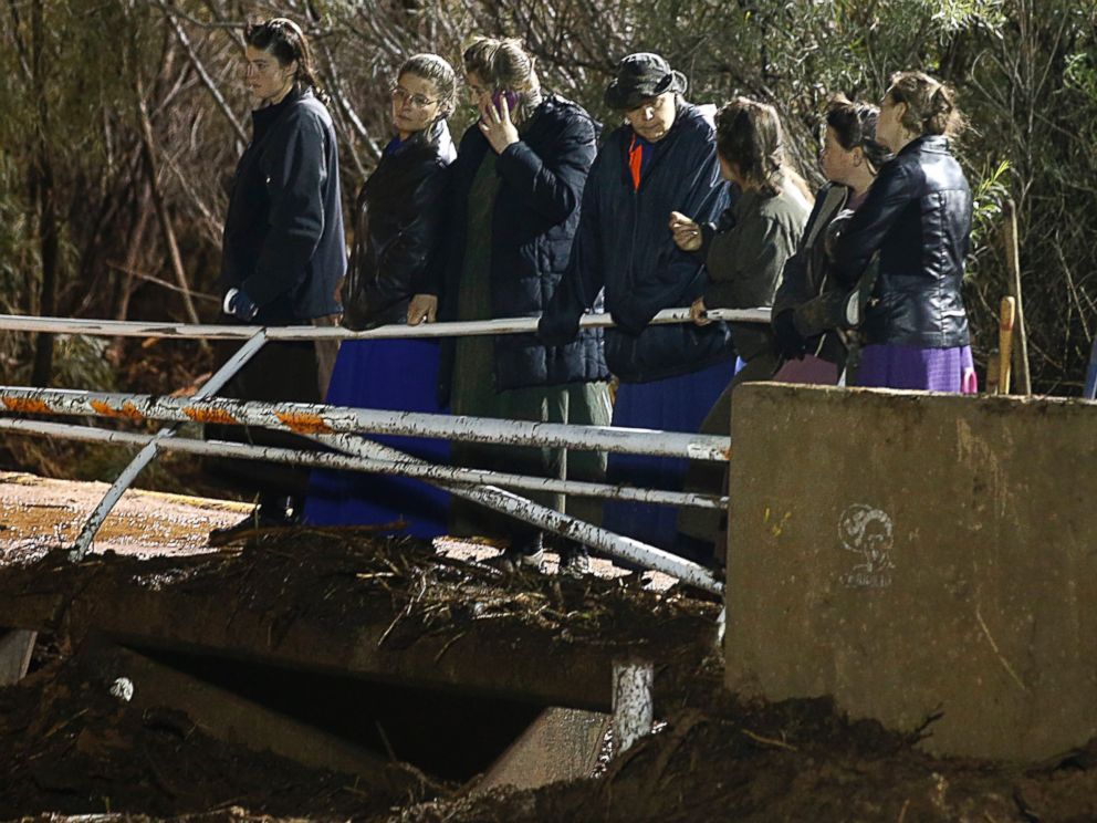 PHOTO:Several woman watch as large construction equipment is used to remove flood debris from Short Creek, Sept. 15, 2015 in Hildale, Utah. 