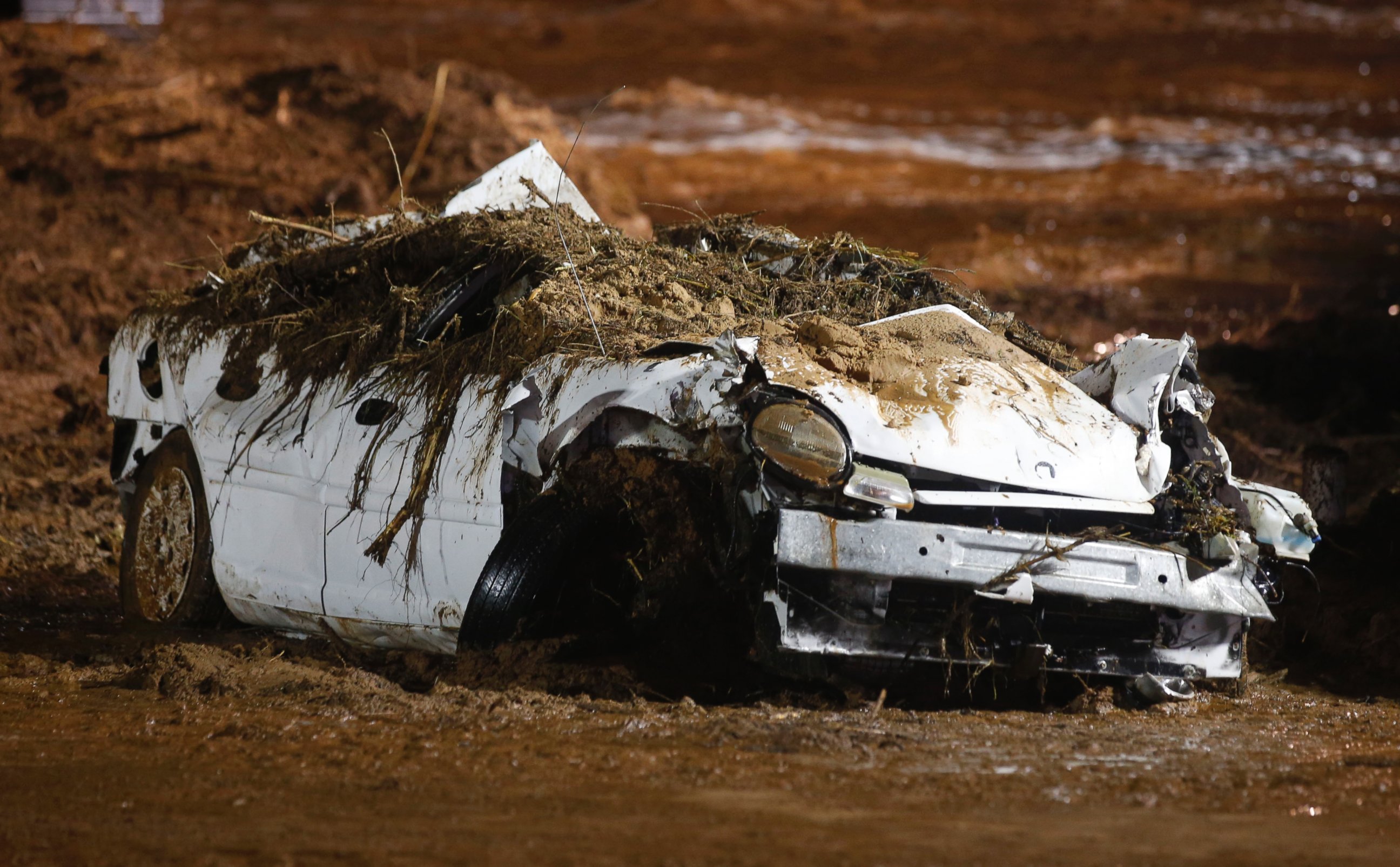 PHOTO: A car sits on the side of the road after being pulled from Short Creek by construction equipment that is removing flood debris from Short Creek as it crosses Central Street, Sept. 15, 2015 in Hildale, Utah