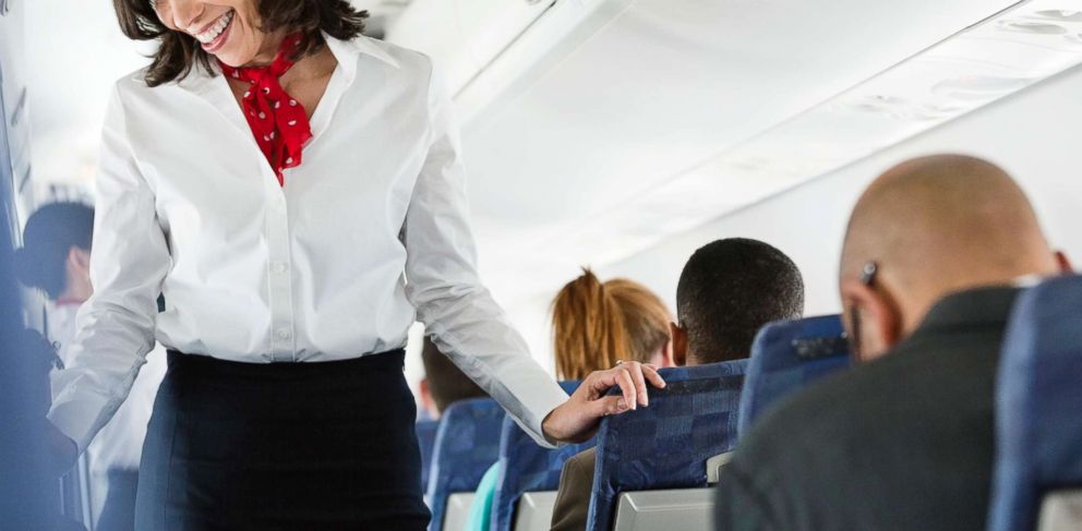 PHOTO: An air hostess helps a passenger.