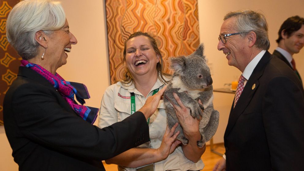 PHOTO: Christine Lagarde pats Jimbelung the koala, held by Michele Barneds, with Jean-Claude Juncker