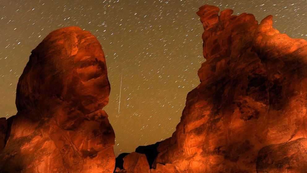 A Geminid meteor streaks between peaks of the Seven Sisters rock formation early Dec. 14, 2010 in the Valley of Fire State Park in Nevada. 