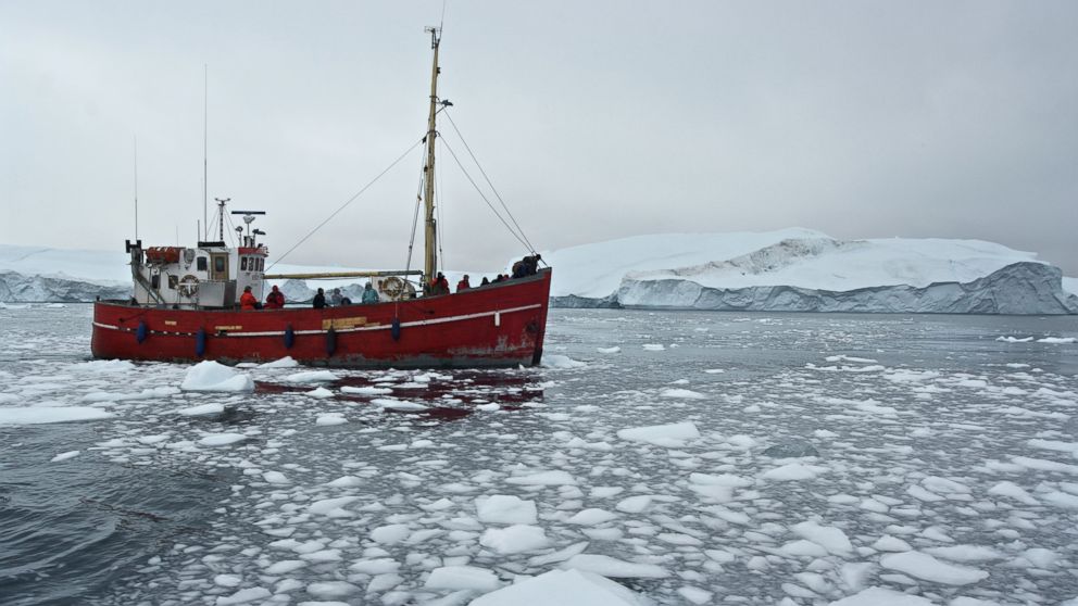 A ship is seen among the icebergs that have broken off the Sermeq Kujalleq Glacier in Ilulissat, Greenland.  