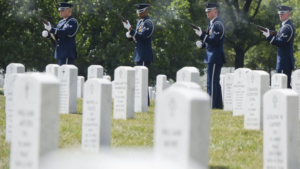 Members of the US Air Force firing party fire three rifle volleys during a burial service for US Air Force pilots Major James Sizemore and Major Howard Andre at Arlington National Cemetery in Arlington, Virginia, Sept. 23, 2013.