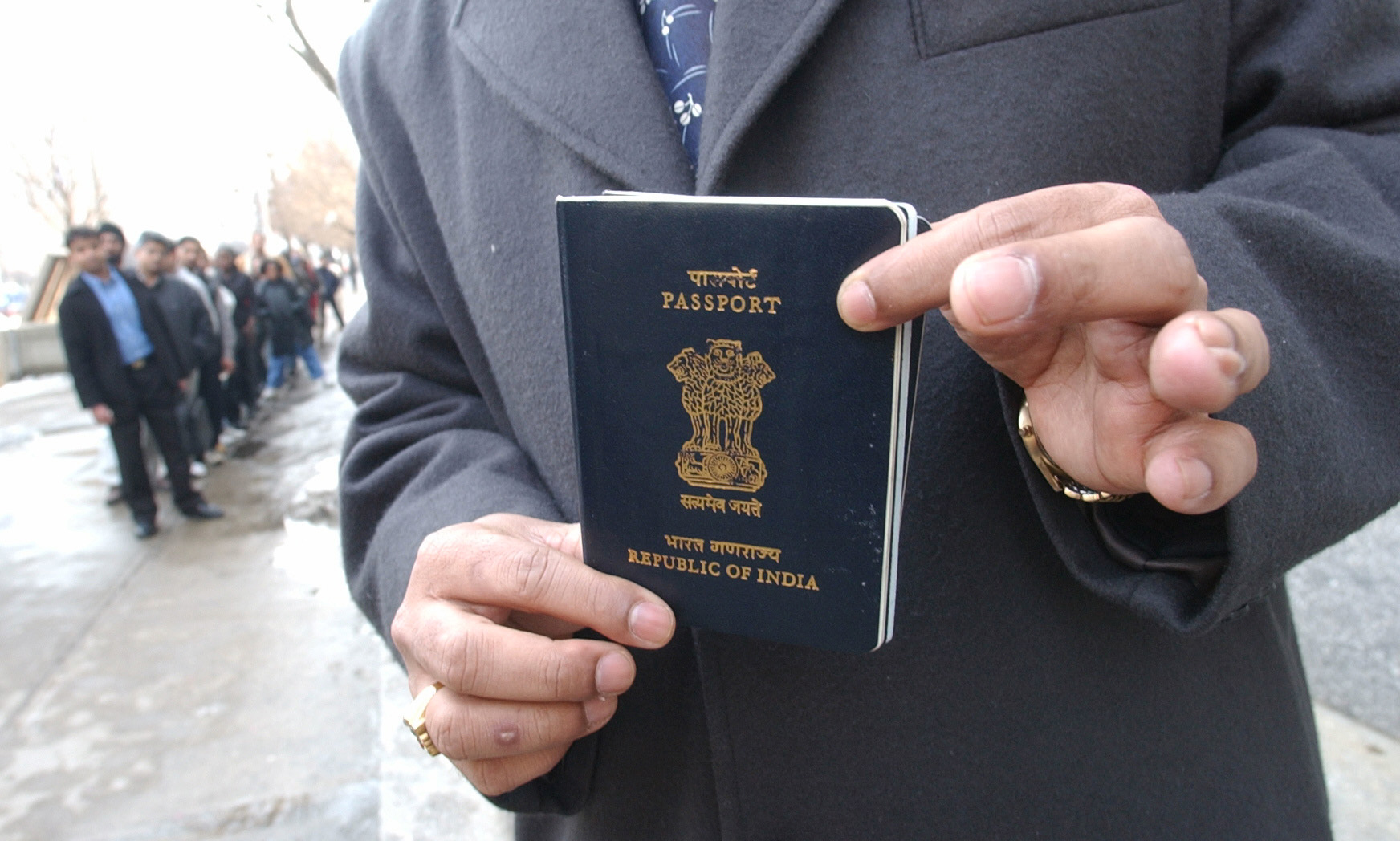 PHOTO: Yog Gorur picks up his India passport from the US CONSULATE in Toronto while other people lineup in front of U.S. CONSULATE to apply or pick up visa applications. 