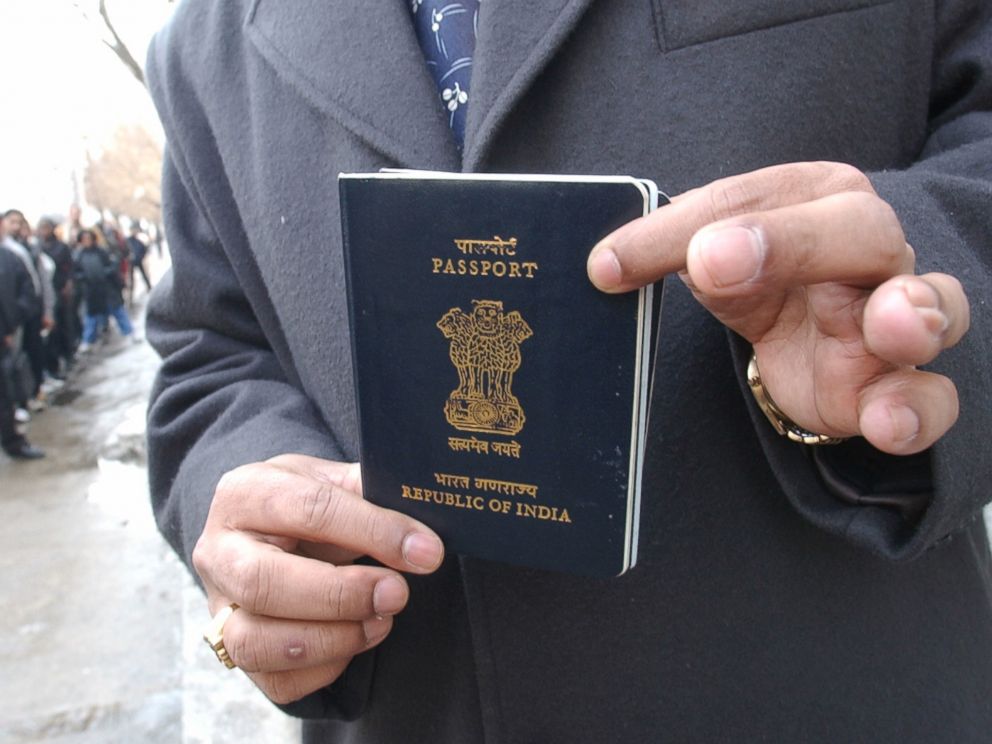 PHOTO: Yog Gorur picks up his India passport from the US CONSULATE in Toronto while other people lineup in front of U.S. CONSULATE to apply or pick up visa applications.