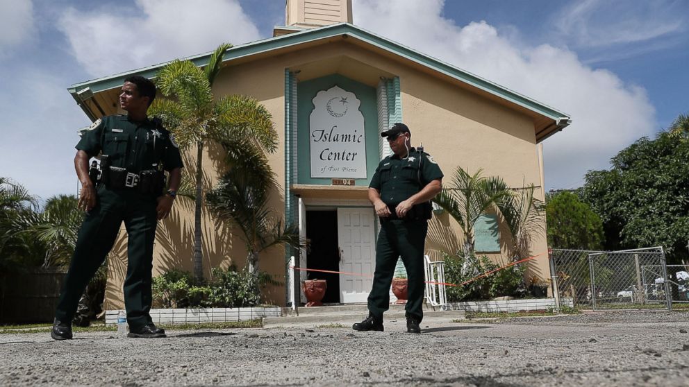 Law enforcement officials investigate a fire at the Islamic Center of Fort Pierce, which was the mosque attended by the Pulse nightclub gunman, who killed 49 people in Orlando, Sept. 12, 2016, in Fort Pierce, Florida. Law enforcement officials are investigating the fire as an arson and say that surveillance cameras show a person approaching the mosque moments before the blaze on Monday morning.  