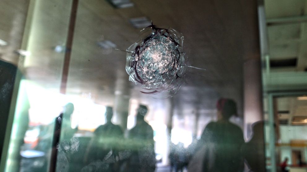 Reflections are cast on the glass where bullet holes remain at Turkey's largest airport, Istanbul Ataturk, Turkey, June 29, 2016, 