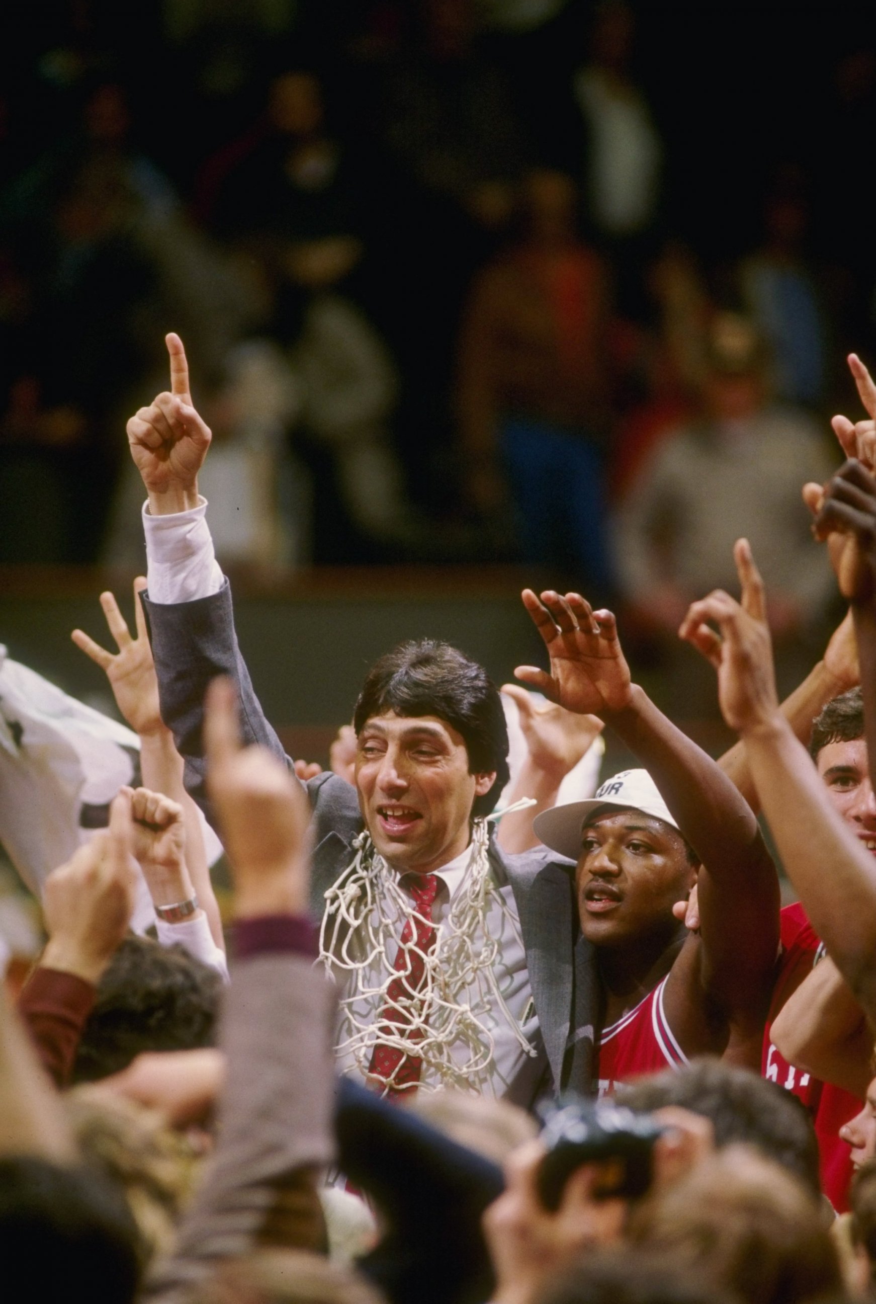 PHOTO: Head coach Jim Valvano of the North Carolina State Wolfpack celebrates with his team after the Wolfpack defeated the Houston Cougars 54-52 in the NCAA men’s basketball championship game at University Arena in Albuquerque, New Mexico.