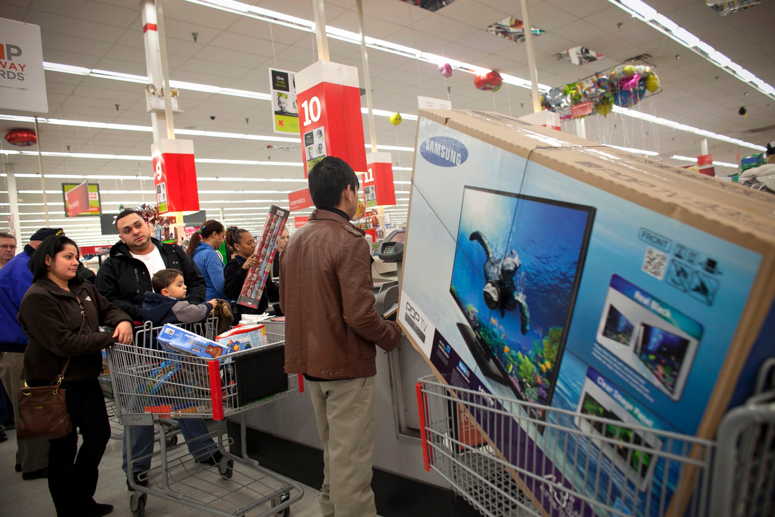 PHOTO: Shoppers wait in a check out line at a Kmart store during the Black Friday sales, Nov. 23, 2012, in Braintree, Mass.
