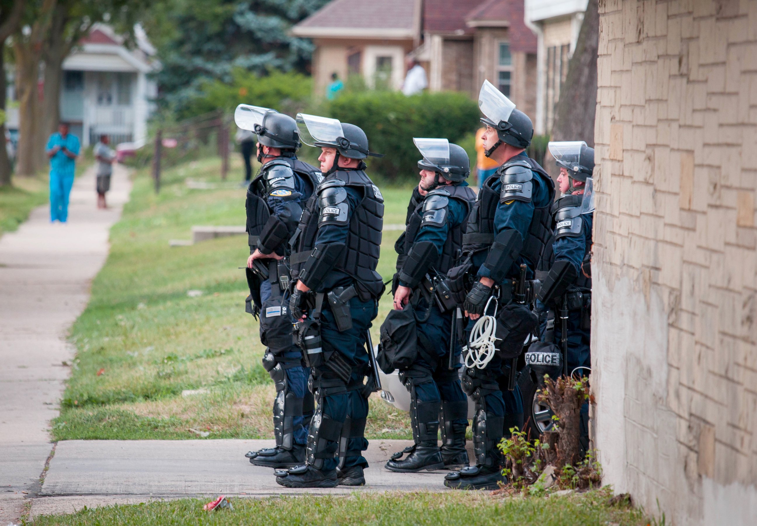 PHOTO: Police in riot gear wait in an alley after a second night of clashes between protestors and police, Aug. 15, 2016, in Milwaukee, Wisconsin.