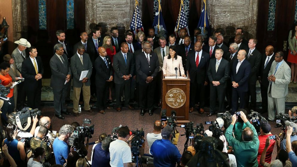 South Carolina Gov. Nikki Haley, surrounded by lawmakers and activists, speaks to the media asking that the Confederate flag be removed from the state capitol grounds, June 22, 2015, in Columbia, S.C.