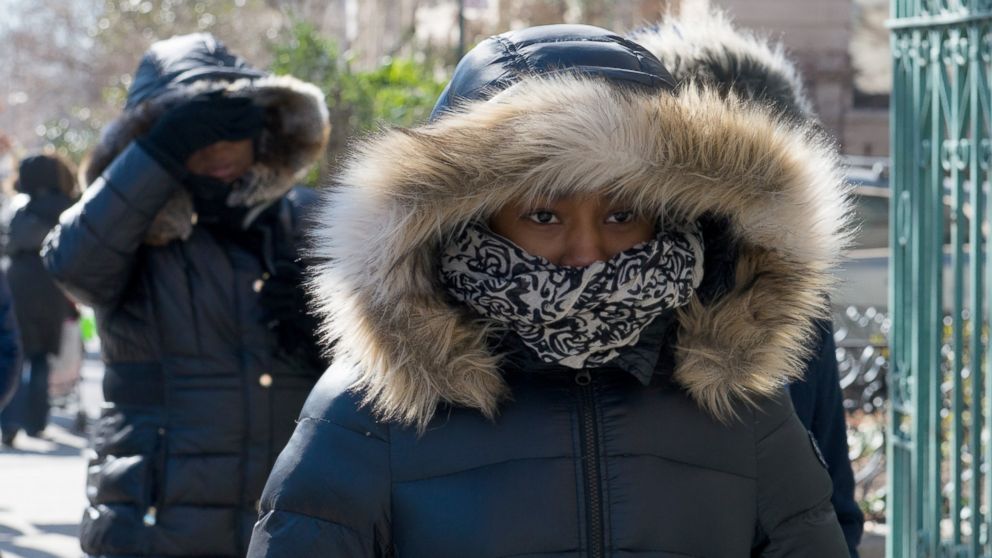 People wear warm winter clothes during an arctic chill that brought frigid temperatures, Feb. 14, 2016, in the Brooklyn, New York.