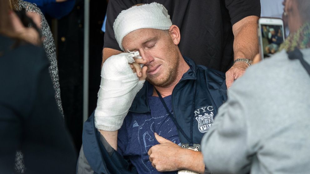 PHOTO: NYPD Police Officer Kenneth Healey, 25, who was attack with a hatchet by Zale Thompson, wipes his tears as he was released from Jamaica Hospital Medical Center located at  8900 Van Wyck Expressway in Queens, Oct. 29, 2014.