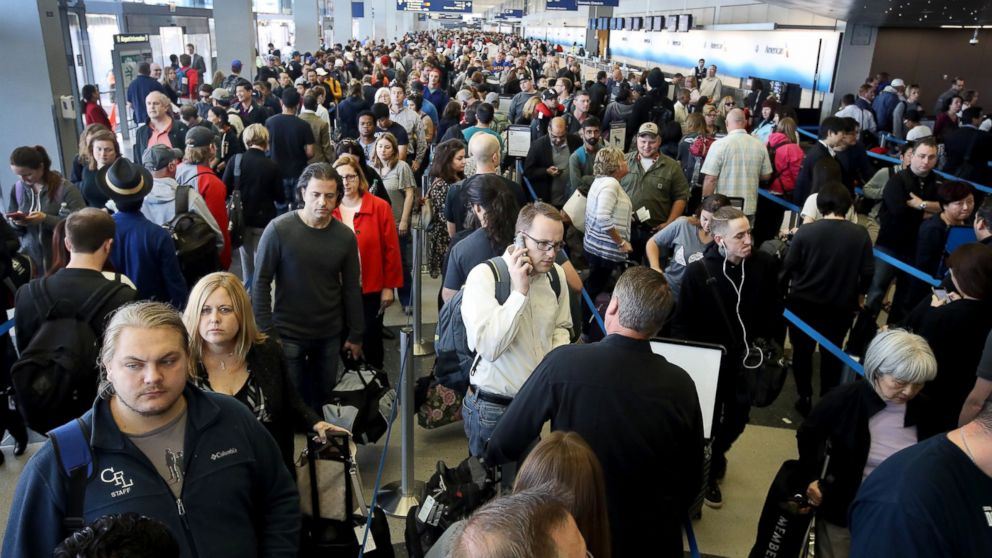 Passengers at O'Hare International Airport wait in line to be screened at a Transportation Security Administration (TSA) checkpoint, May 16, 2016, in Chicago.