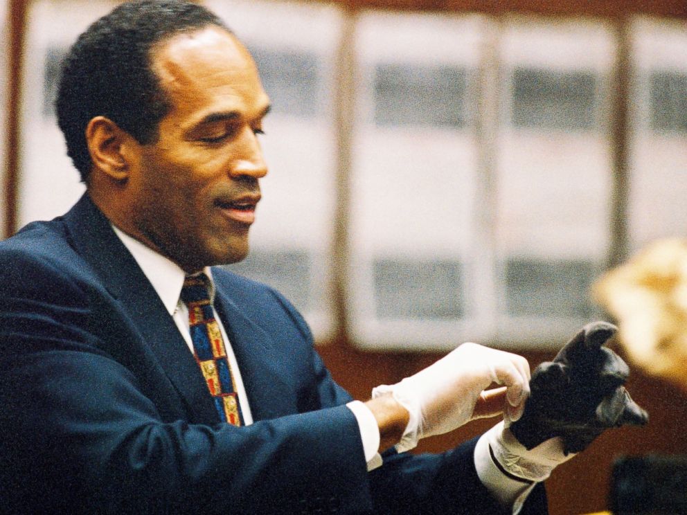 PHOTO: O.J. Simpson tries on a leather glove allegedly used in the murders of Nicole Brown Simpson and Ronald Goldman during testimony in Simpson's murder trial, June 15, 1995, in Los Angeles.
