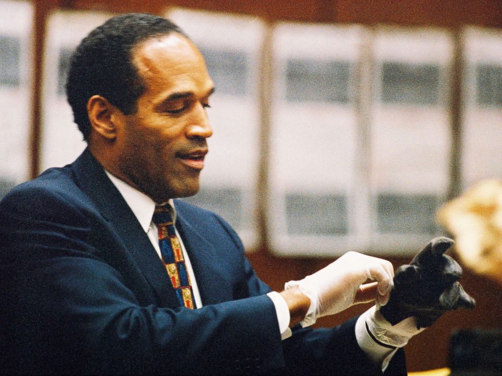 PHOTO: O.J. Simpson tries on a leather glove allegedly used in the murders of Nicole Brown Simpson and Ronald Goldman during testimony in Simpson's murder trial June 15, 1995 in Los Angeles.