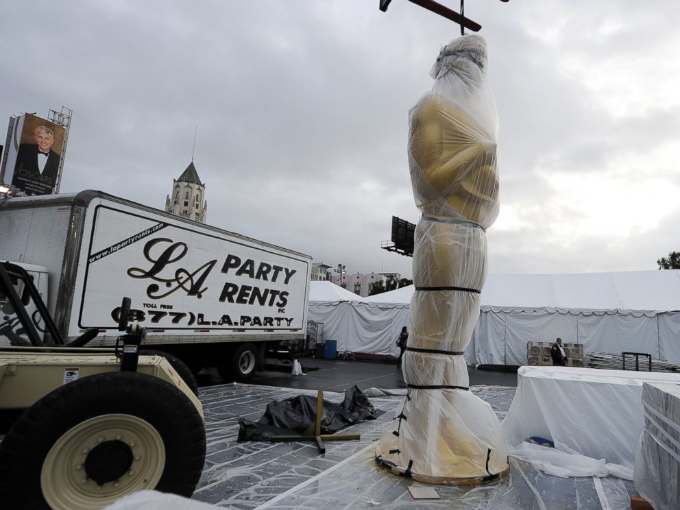 PHOTO: An Oscar statue is covered in plastic near the red carpet as preparations continue for the 86th Annual Academy Awards, March 1, 2014, in Hollywood, Calif.