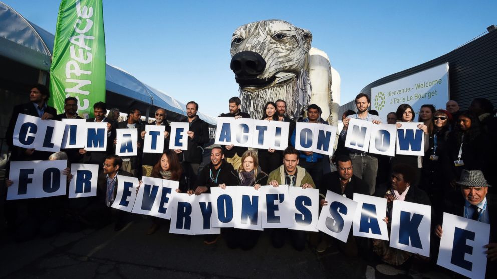 PHOTO: Greenpeace activists hold signs reading "Action Now for everyone's sake" in front of Greenpeace's giant puppet polar bear Aurora during a protest at the COP21 United Nations climate change conference in Le Bourget, outside Paris, Dec. 9, 2015. 