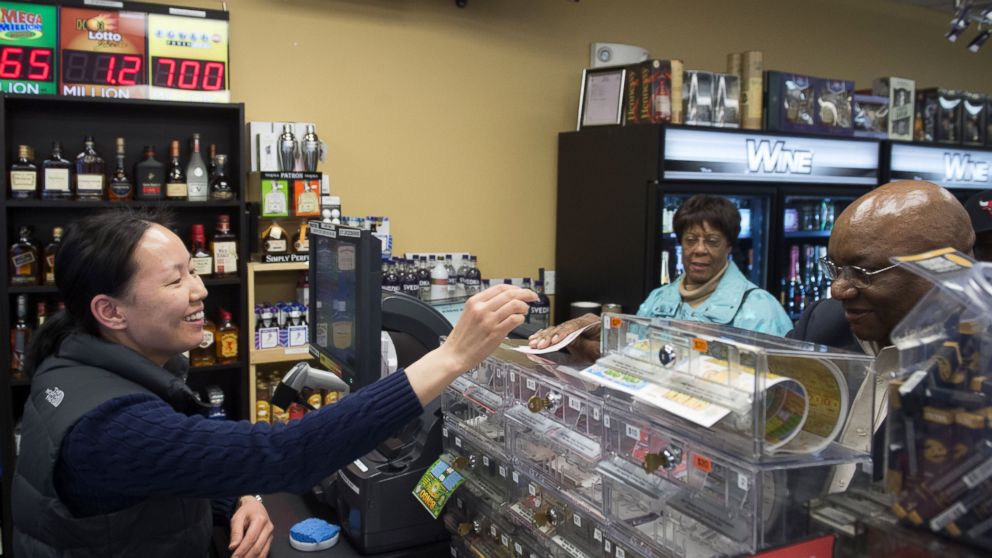 Ali Tsedev sells Powerball lottery tickets at a convenience store in Washington, Jan. 7, 2016.