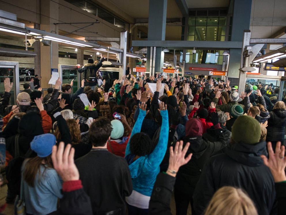 PHOTO: Black Lives Matter protesters hold their hands in the air and chant, Hands up, dont shoot, at the Minneapolis-St. Paul International airport Lightrail stop, Dec. 23, 2015 in Minneapolis.