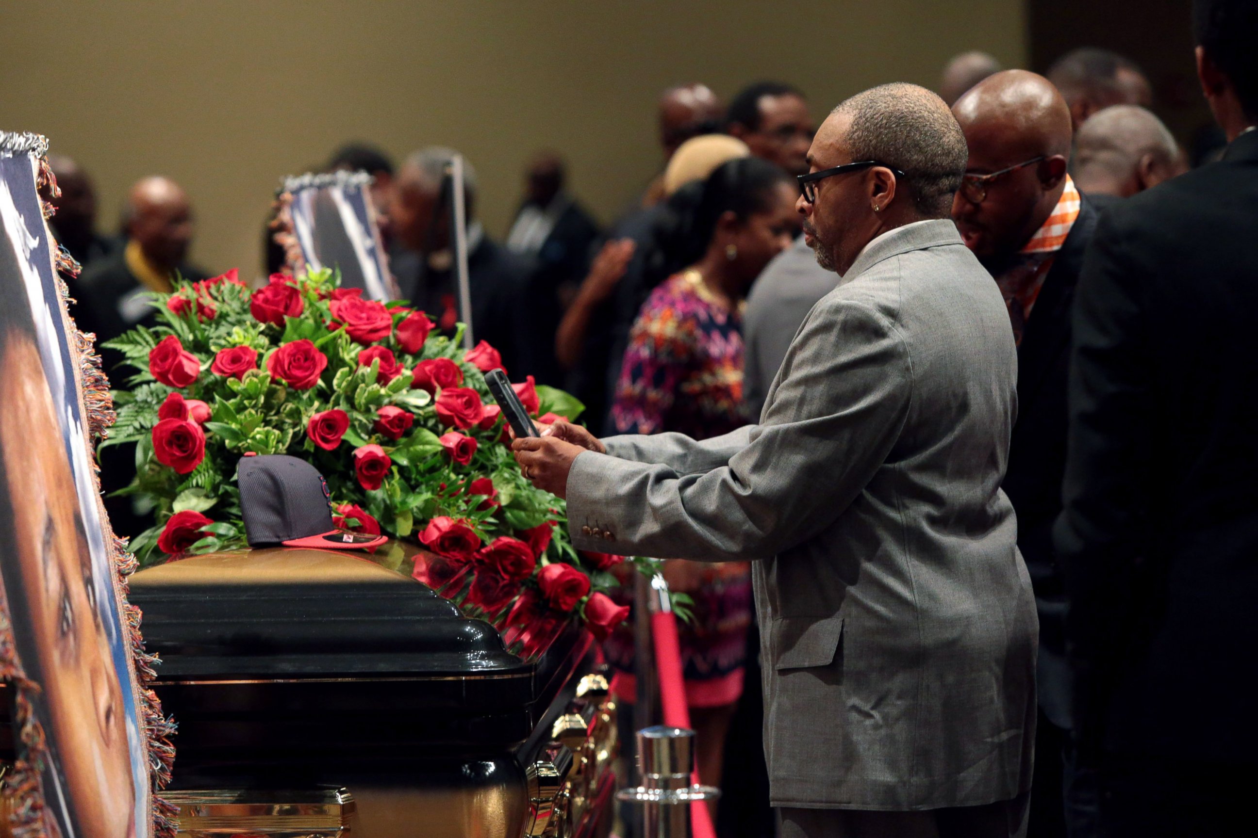 PHOTO: Director Spike Lee takes a picture of a black St. Louis Cardinals baseball cap that rests on top of the casket of Michael Brown inside Friendly Temple Missionary Baptist Church awaiting the start of his funeral on Aug. 25, 2014 in St. Louis Mo.