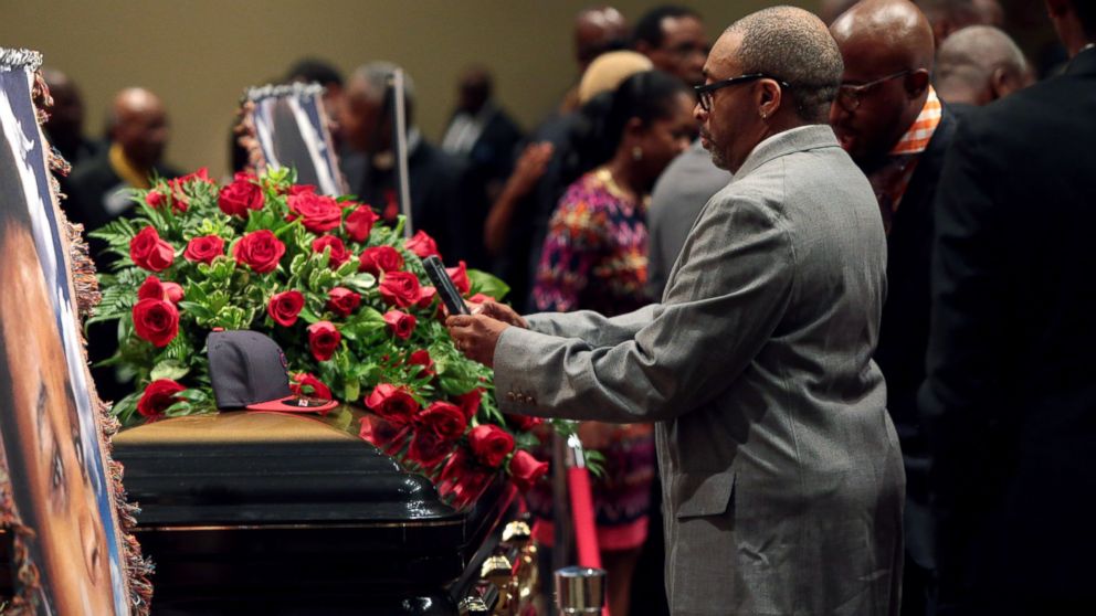 PHOTO: Director Spike Lee takes a picture of a black St. Louis Cardinals baseball cap that rests on top of the casket of Michael Brown inside Friendly Temple Missionary Baptist Church awaiting the start of his funeral on Aug. 25, 2014 in St. Louis Mo.