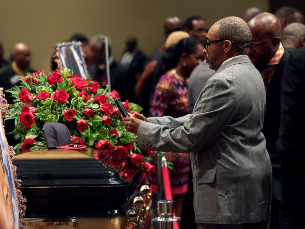 PHOTO: Director Spike Lee takes a picture of a black St. Louis Cardinals baseball cap that rests on top of the casket of Michael Brown inside Friendly Temple Missionary Baptist Church awaiting the start of his funeral on Aug. 25, 2014 in St. Louis Mo.