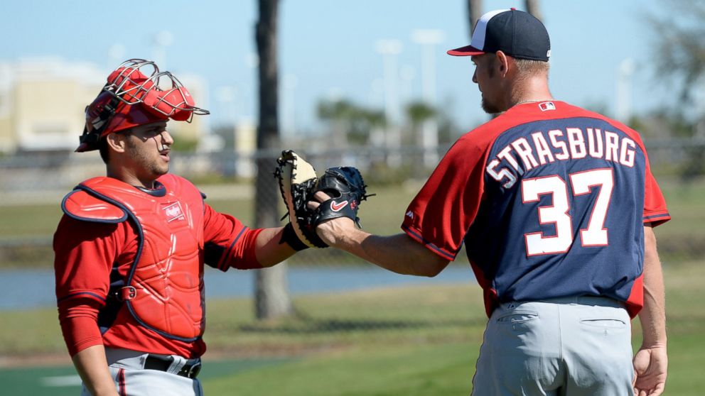 Washington Nationals starting pitcher Stephen Strasburg, right, greets catcher Jhonatan Solano, left, after their bullpen session during spring training workouts on Feb. 16, 2014 in Viera, Fla.