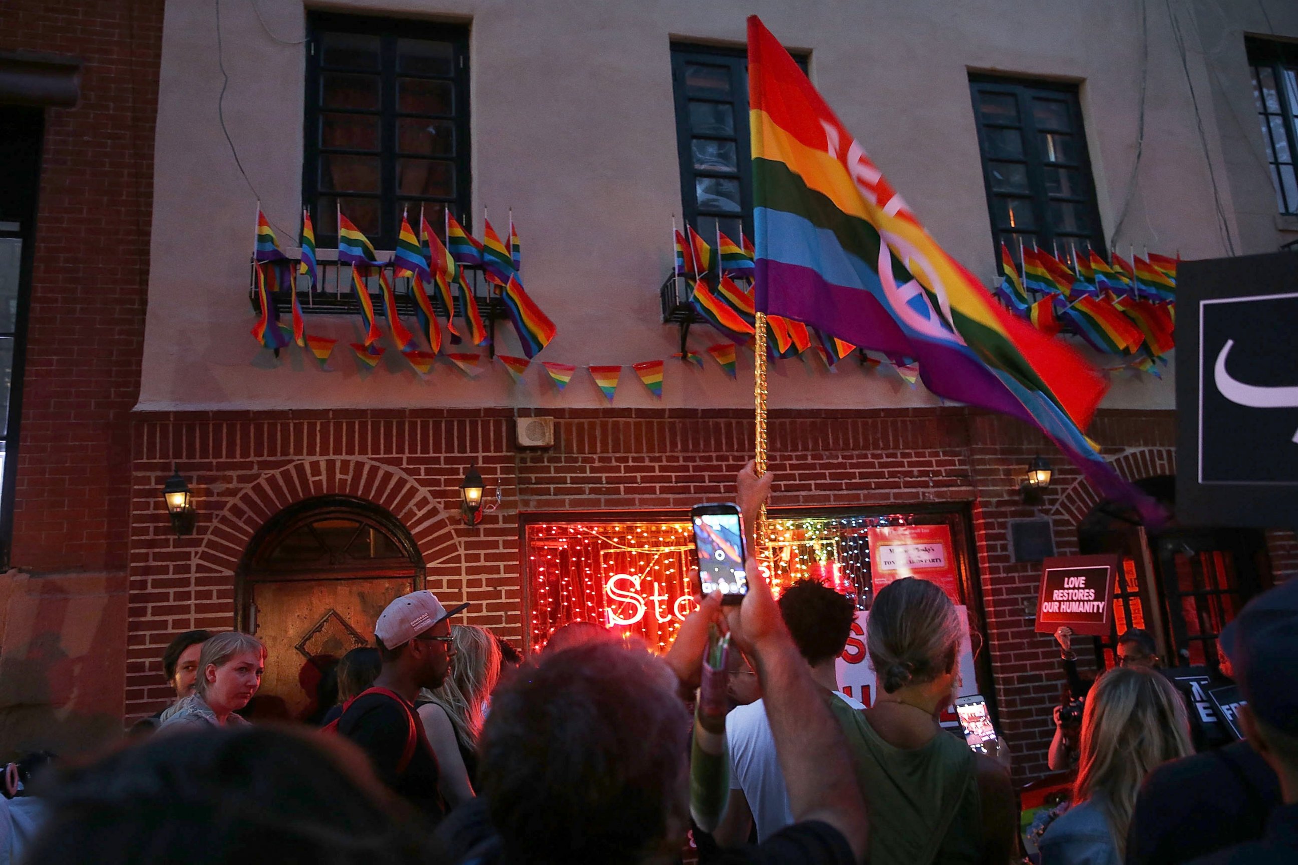 PHOTO: Mourners gather outside of the iconic New York City gay and lesbian bar the Stonewall Inn to light candles,lay flowers and grieve for those killed in Orlando last evening, June 12, 2016, in New York City. 