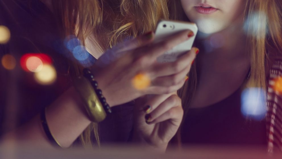 In the cult hit film, "Mean Girls," the Burn Book was all the gossip. Now, it's a cell phone app that is causing school officials and parents concern. Teenage girls are seen here in this undated stock photo.