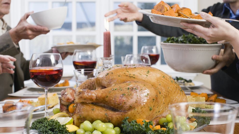 A family is seen having Thanksgiving dinner in this stock photo.