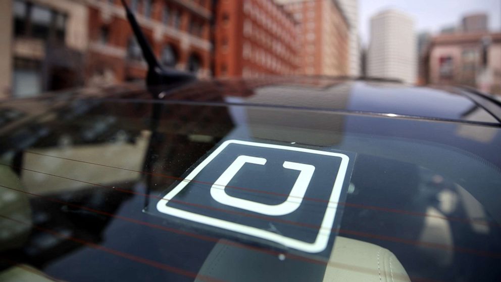 Uber driver Dean Johnson waits for a customer outside South Station in Boston, April 22, 2016.