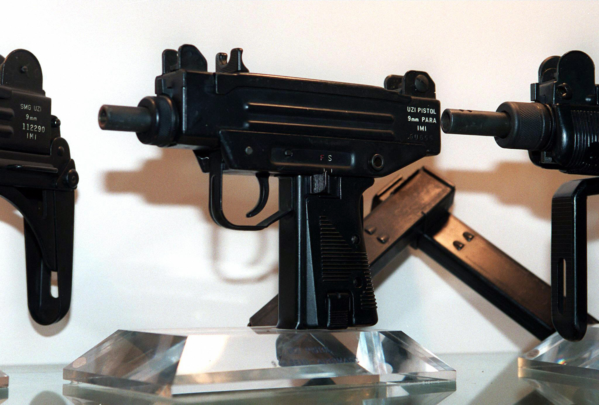 PHOTO: An Uzi pistol,center, is displayed next to the larger Uzi submachine gun models, at the Israeli Military Industries (IMI) in Ramat Hasharon, Israel, Nov. 11, 1997.